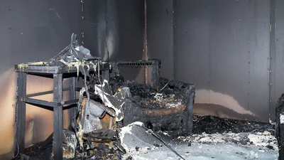 a burnt down table with ashes on floor