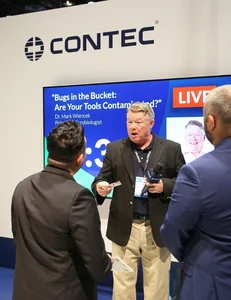 man in black blazer speaking at conference