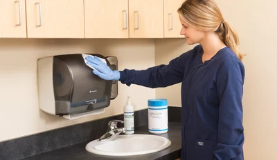 Woman cleaning patient room
