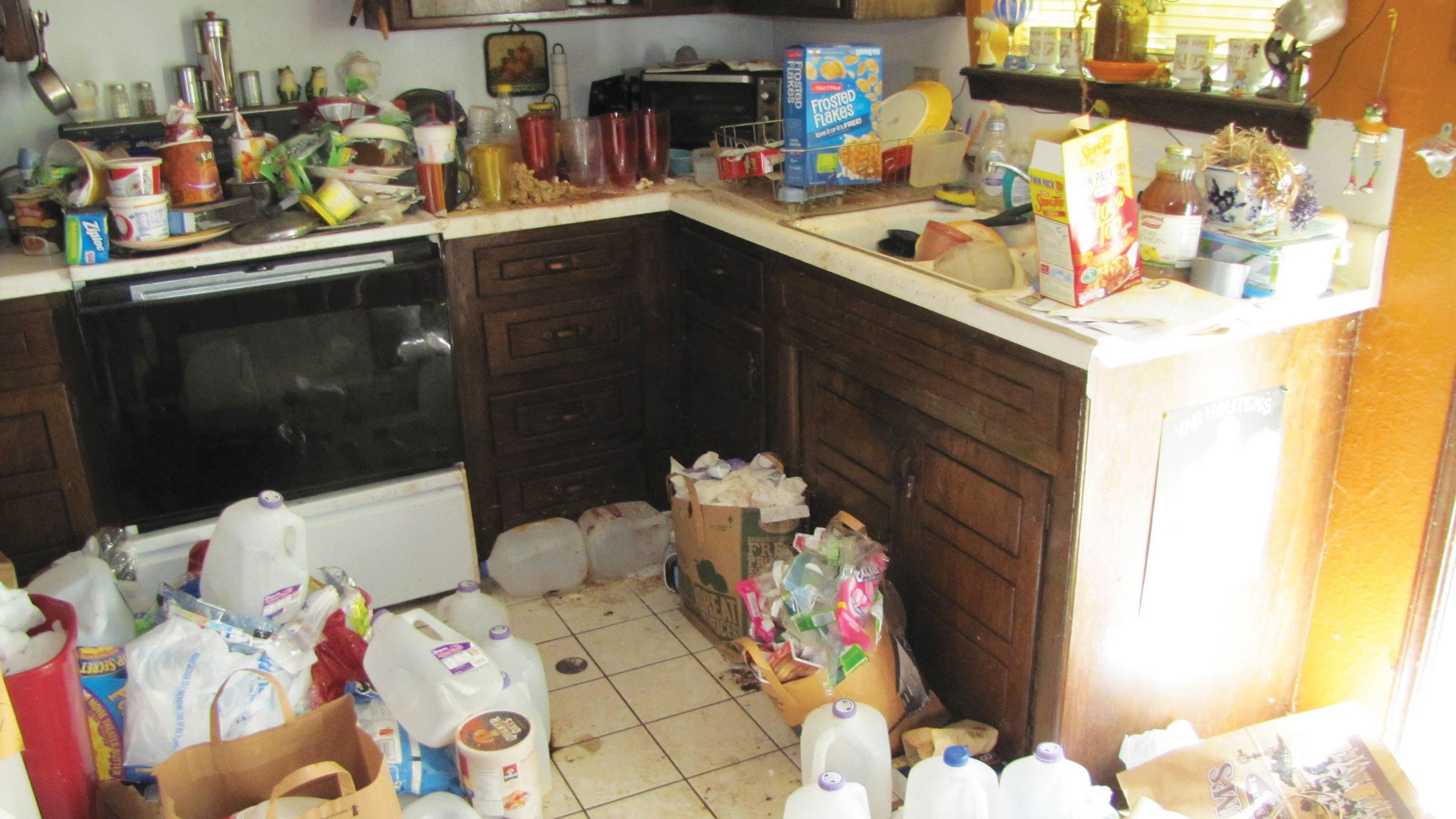 a dirty kitchen with trash everywhere 