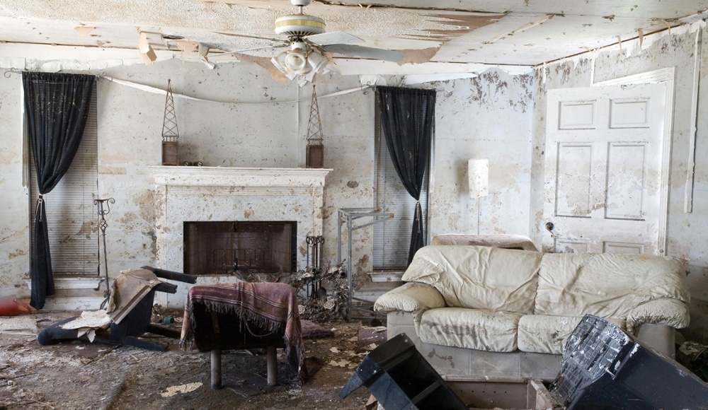 image of a water damaged living room with white furniture