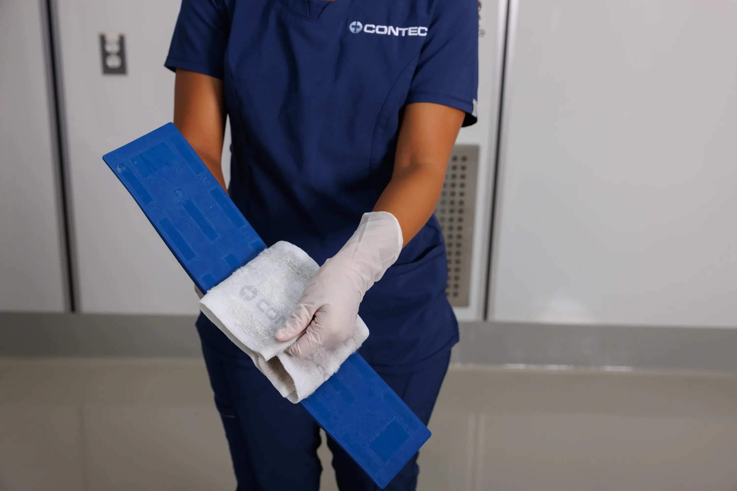 EVS worker removing a Premira Disposable Microfiber Mop Pad